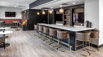 a large bar with stools in a lobby of a restaurant at Expo, Minneapolis, 55414